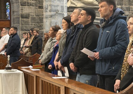 Worshippers standing in their pews.